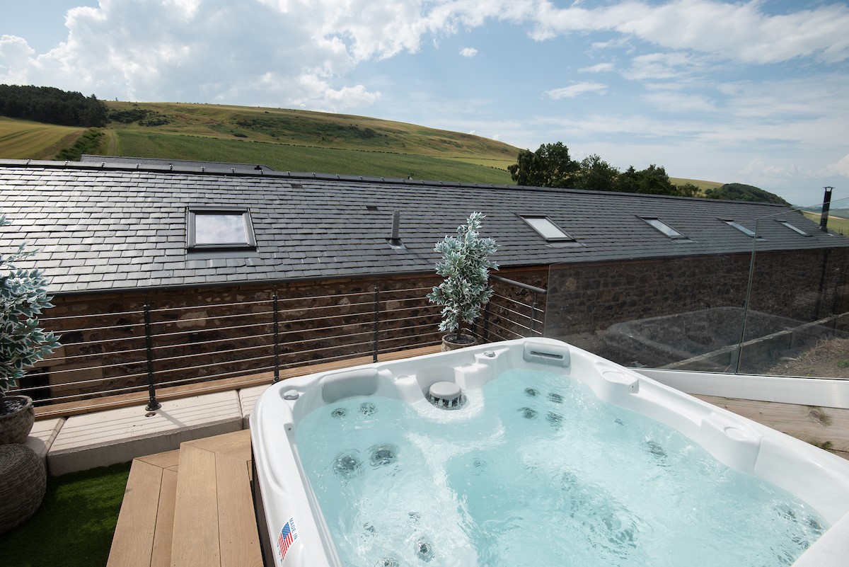 The Old Byre at West Moneylaws - take a relaxing soak in the hot tub while enjoying fabulous views