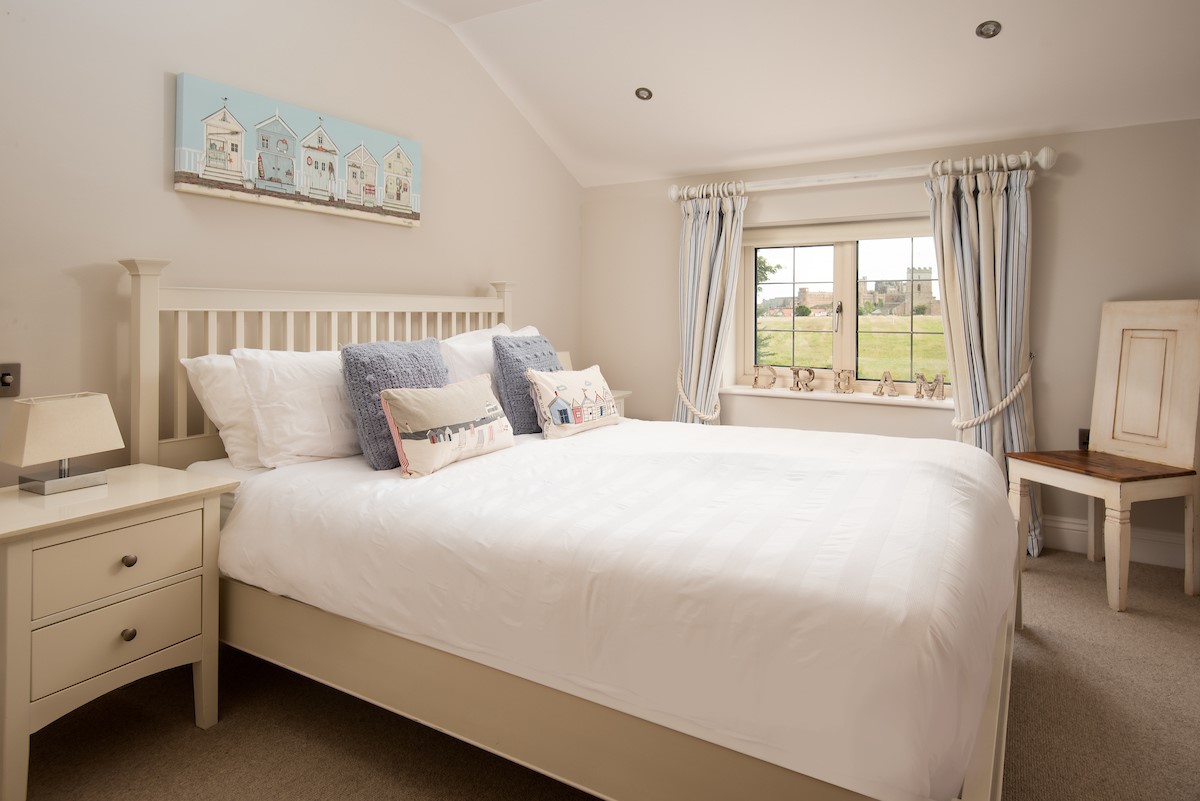 North Star House - bedroom two with king size bed and views towards Bamburgh Castle