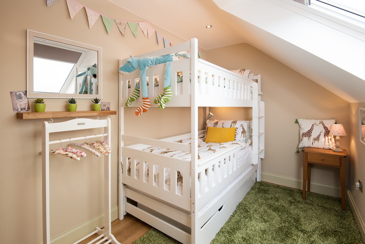 Goose Cottage - bedroom three with full-size bunk beds and miniature clothing rail