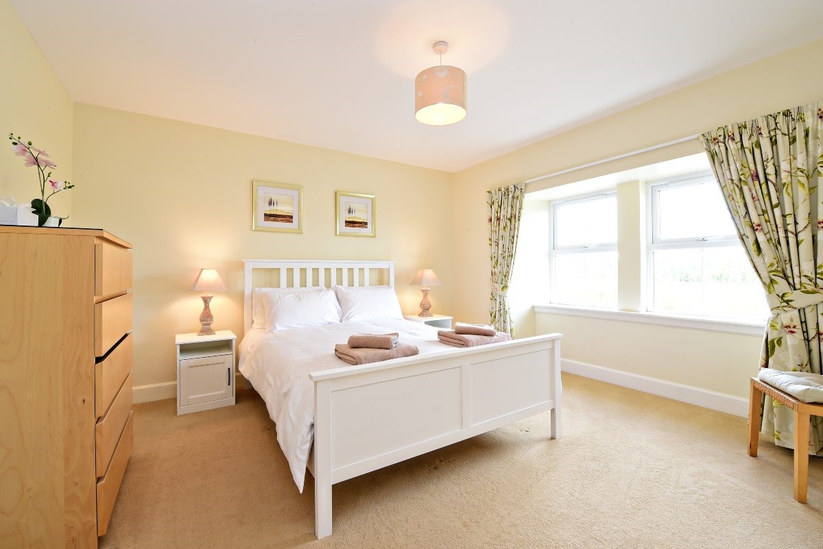 Hawthorn House - bedroom two with king size bed and large double window with views of the surrounding fields