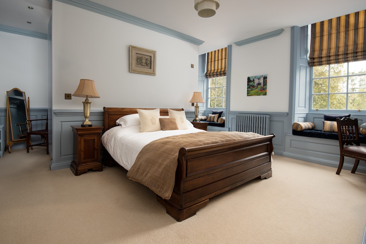 Eslington East Wing - bedroom two with 5' king size sleigh bed and matching bedside tables with lamps