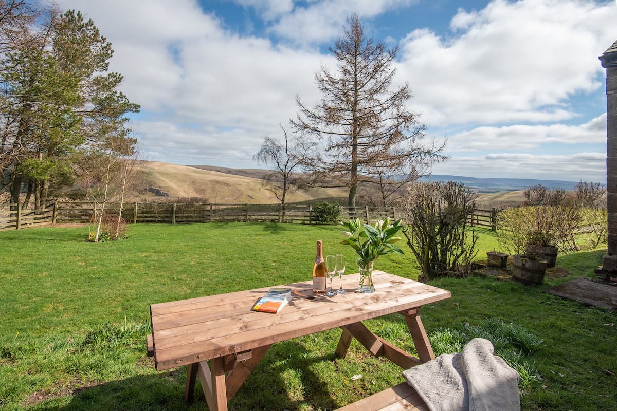 The School House - outdoor dining area in the shared garden with views of the rolling Upper Coquet valley
