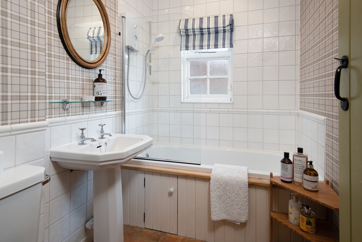 The Cottage - bathroom with bath and shower over