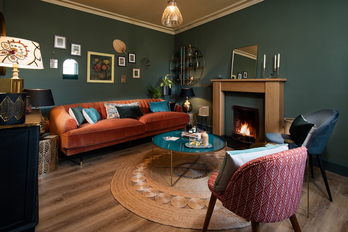 Mulberry Cottage - sitting room with open fire and large double sofa