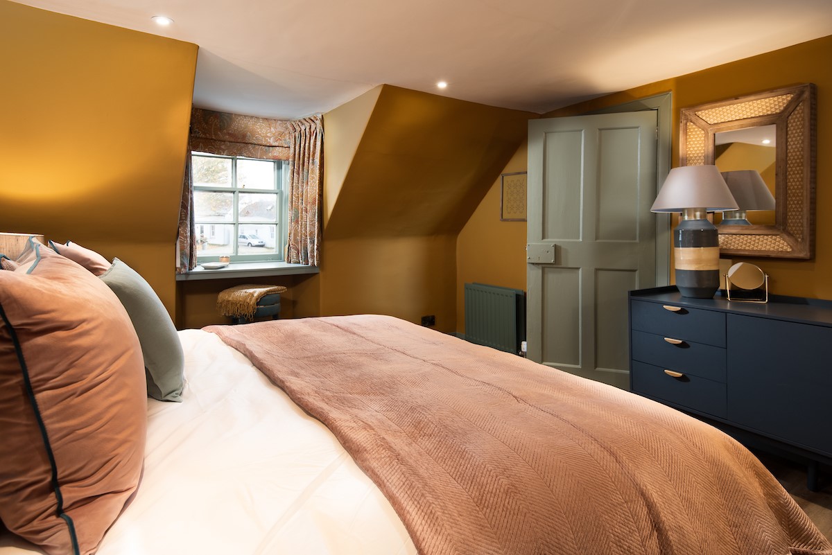Bedroom one - with rich ochre walls