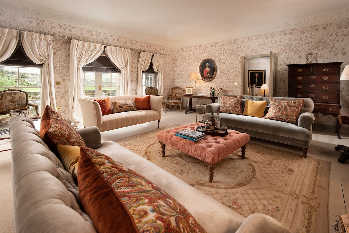 Broadgate House - drawing room with large sofas, occasion chairs and double doors leading to the garden