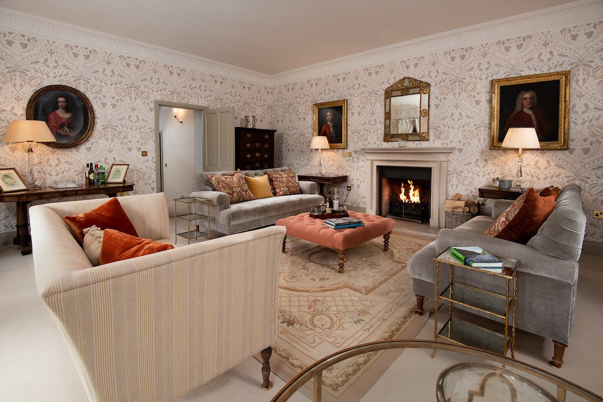 Broadgate House - drawing room with large sofas and open fire