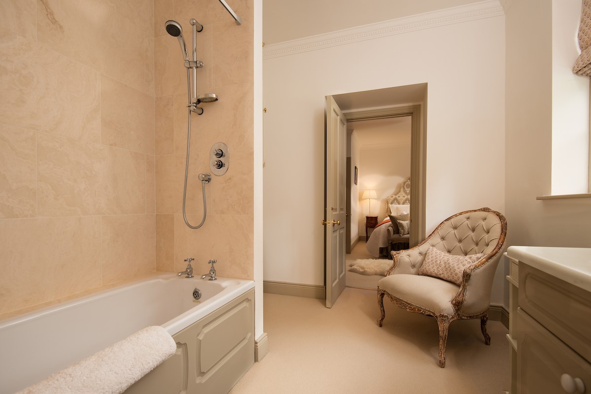 Broadgate House - bedroom one en-suite bathroom with bath with shower over, WC and basin