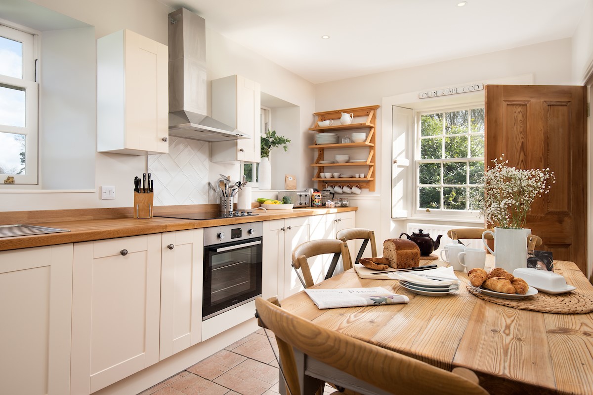 Garden House - kitchen with dual aspect views and dining table with seating for six
