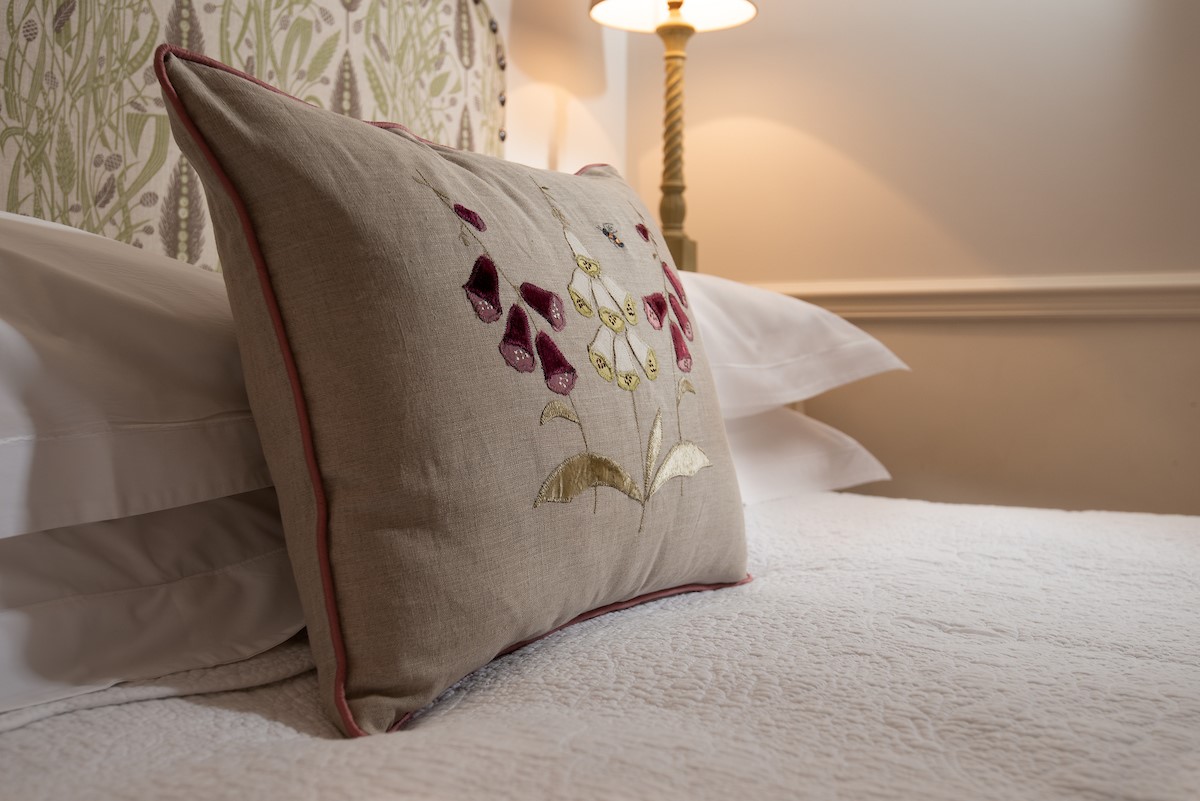 Garden House - floral cushion in bedroom three
