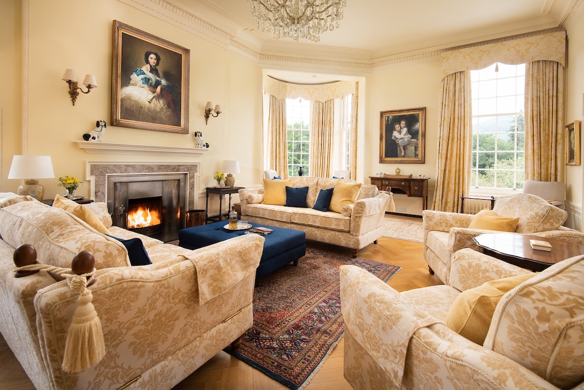 Fairnilee House - drawing room with ample seating around the open log fire
