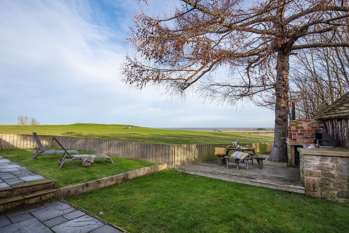 Castle View Cottage - a multi-level garden to the rear benefits from far-reaching views toward The Holy Island of Lindisfarne