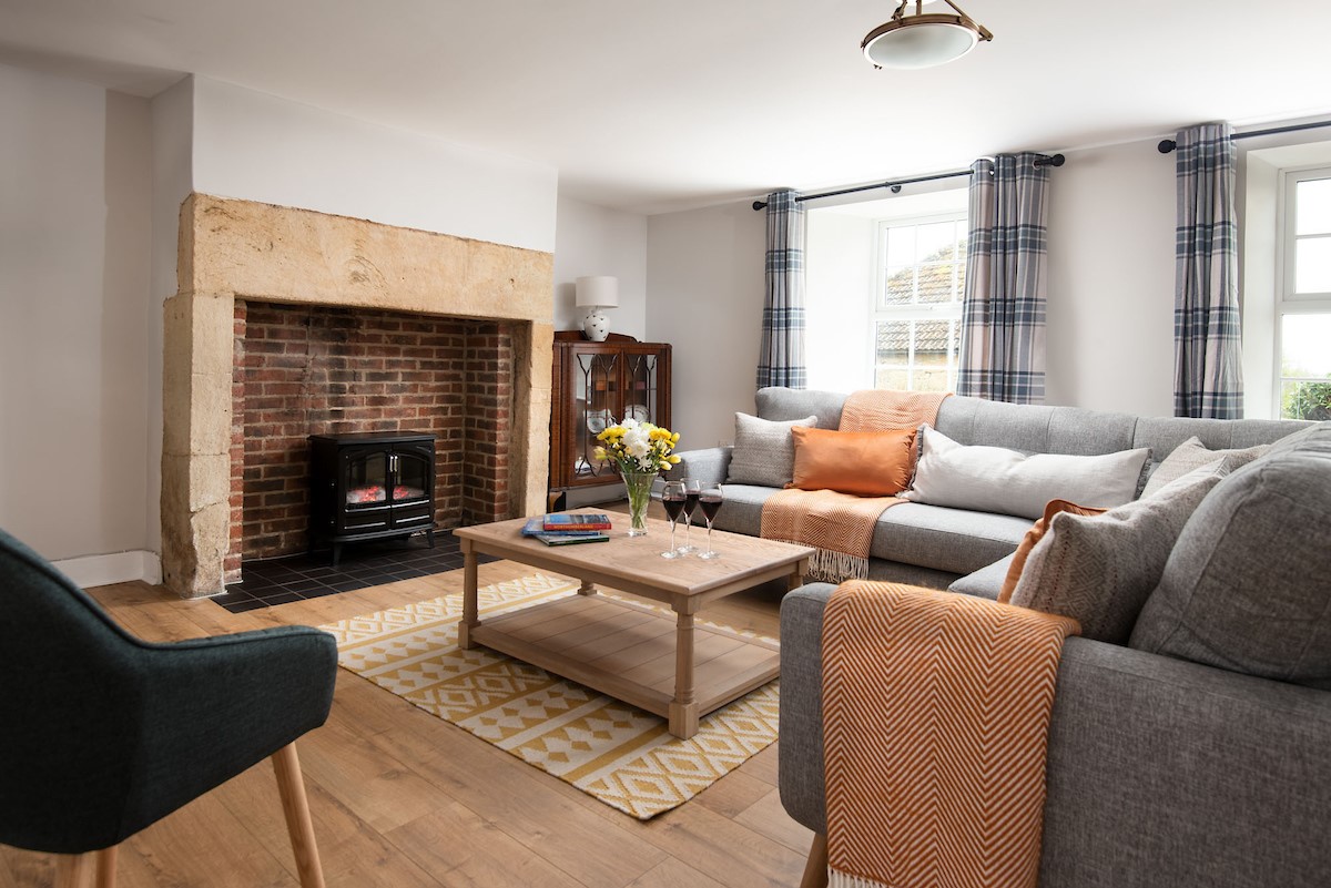 Grange House - sitting room with cosy log-effect electric fire and ample seating