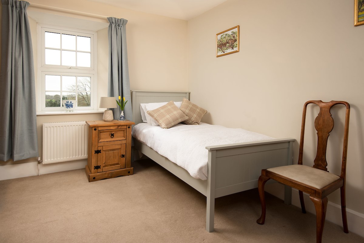Grange House - bedroom two with single bed, bedside table, wardrobe and chair