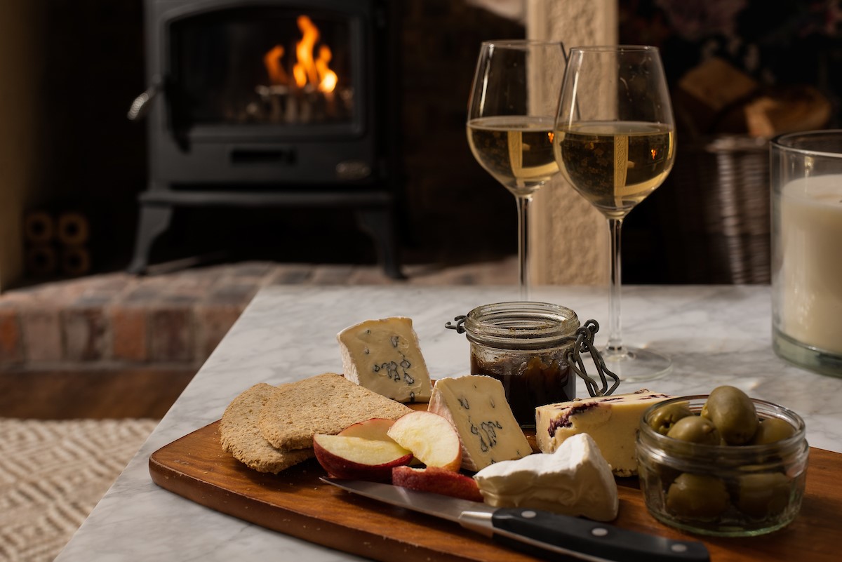 Castle View Cottage - enjoy the warmth of the wood burner alongside delicious nibbles