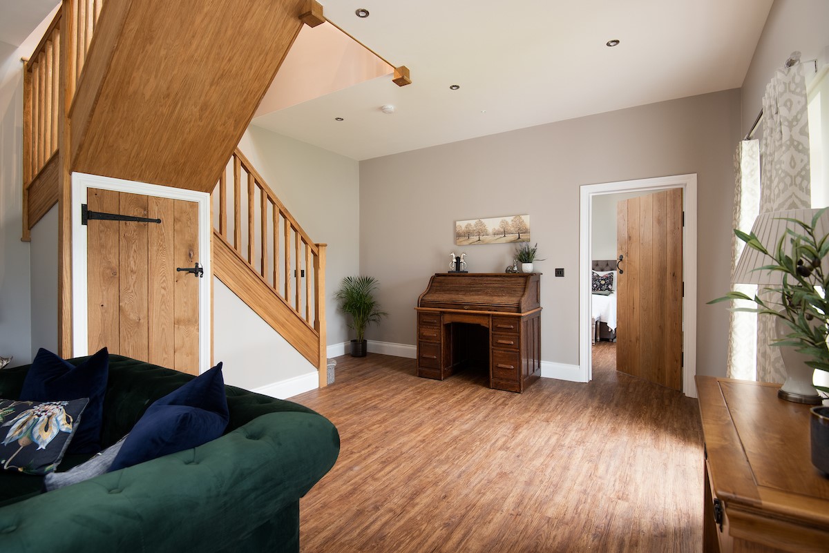 Granary View, Brockmill Farm - sitting room with door leading to the ground floor bedroom and stairs to the upper floor