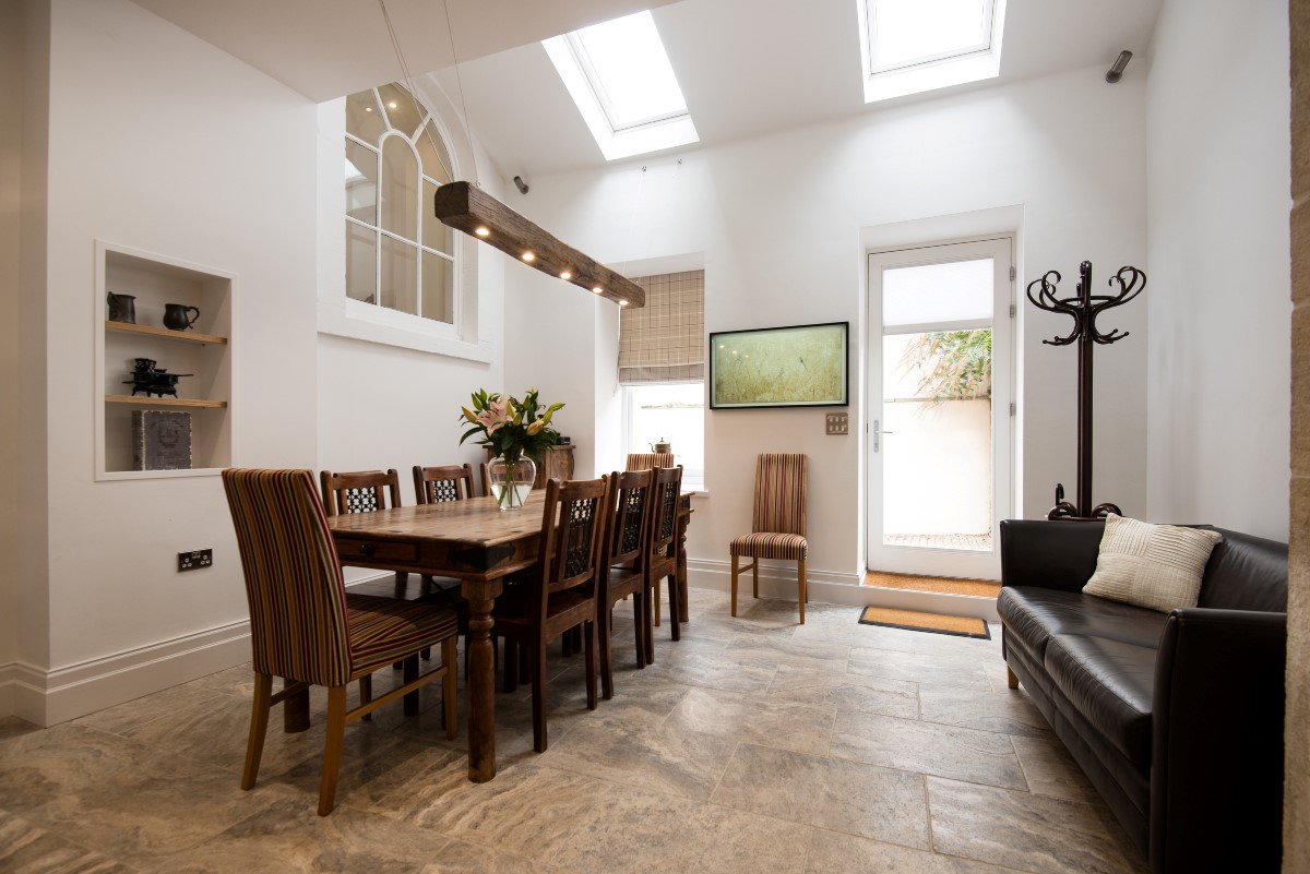 Number One Clayport Street - the double-height dining area with large table and sofa