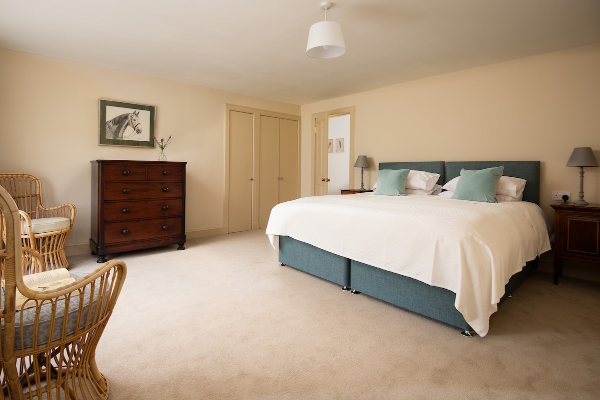 Wark Farmhouse - bedroom two with zip and link beds, inbuilt wardrobes and chest of drawers