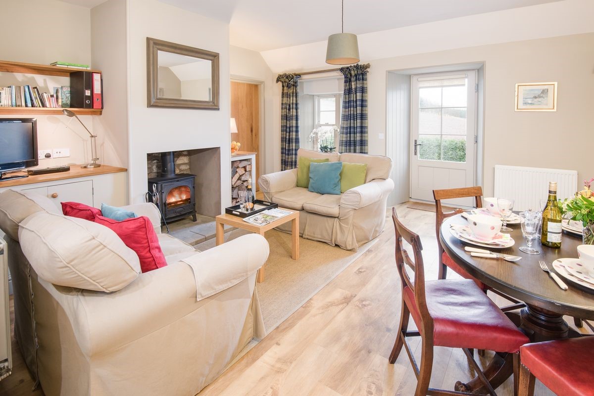 Barley Hill Cottage - open-plan living area with sofas around the wood burning stove