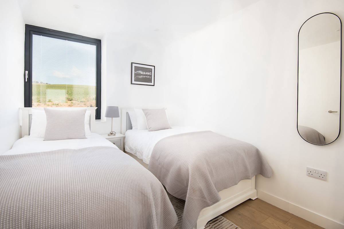 3 The Bay, Coldingham - bedroom two with twin beds and view of fields to the rear of the apartment block
