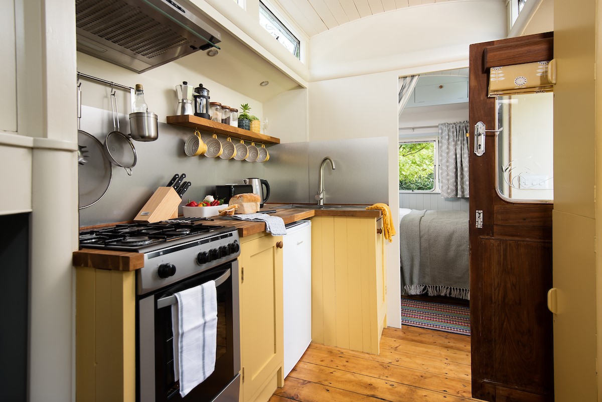The Showman's Wagon - kitchen complete with cooker, 4 ring gas hob and fridge