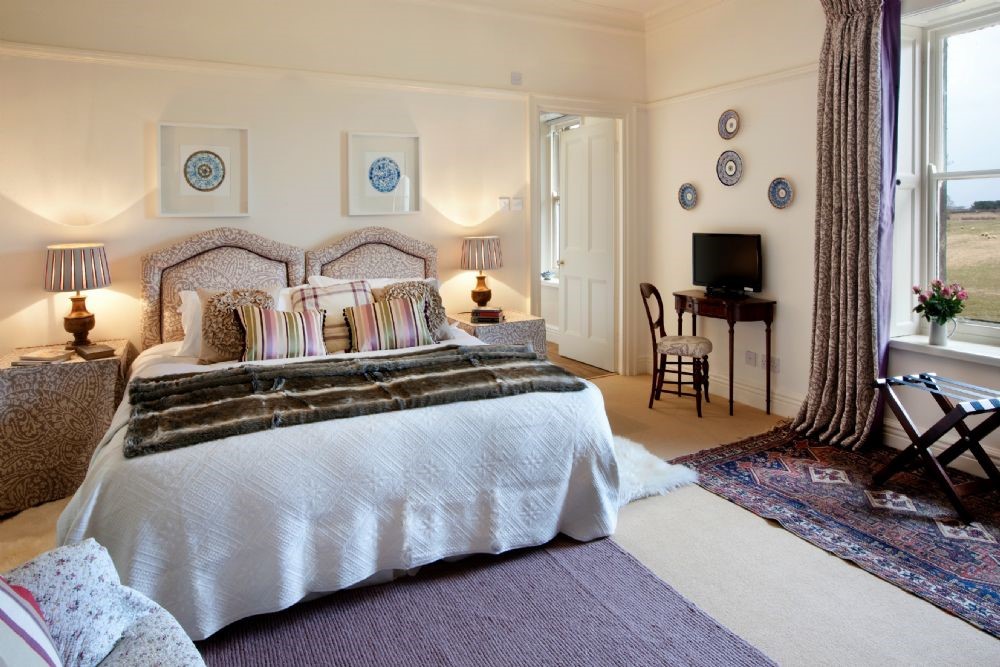 Brunton House - bedroom two with super king bed, bedside tables and dressing table