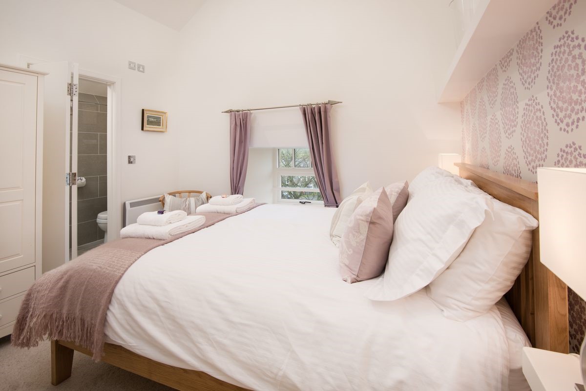 Budle Bay Loft - bedroom one with king size bed and en suite bathroom