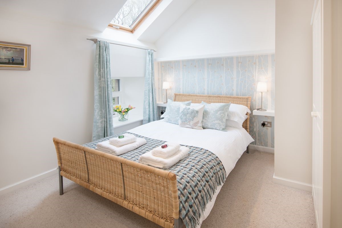 Budle Bay Loft - bedroom two with double bed and blue tones