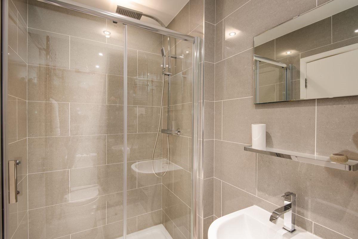 Budle Bay Loft - family bathroom with walk-in shower, WC and basin