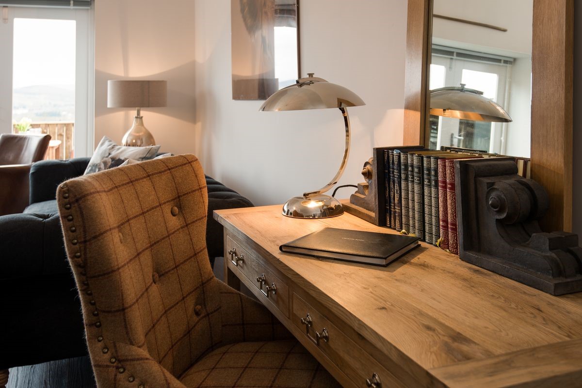 Byre - desk with tartan armchair in sitting room