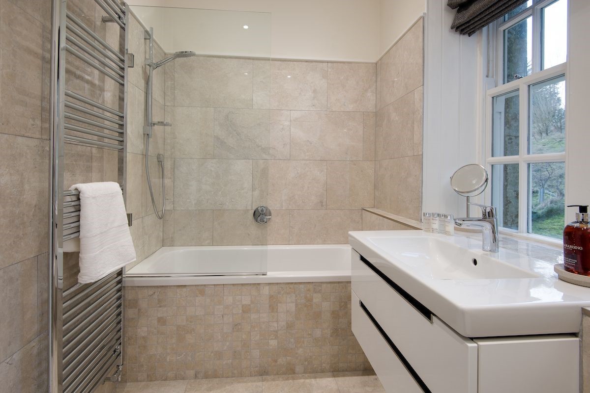 Chaffinch Cottage - family bathroom with bath and shower over, towel rail and basin