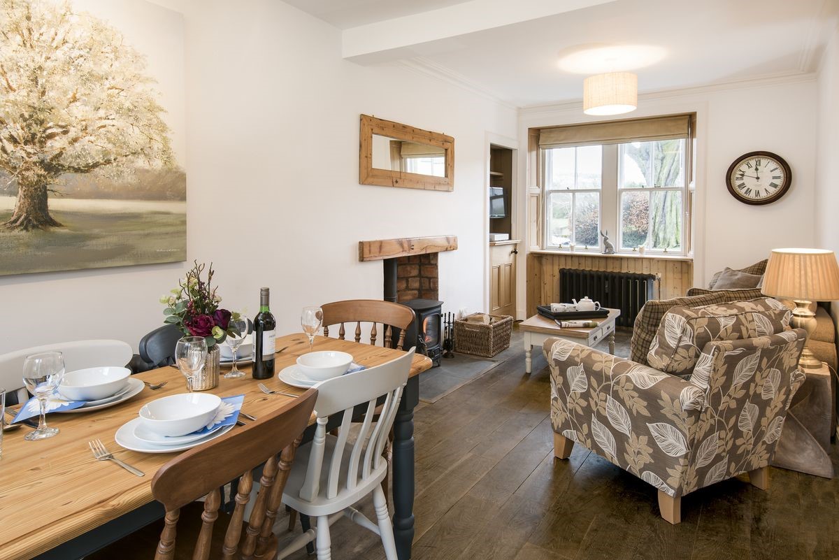 Chestnut Cottage - open-plan sitting room with dining area and wood burning stove