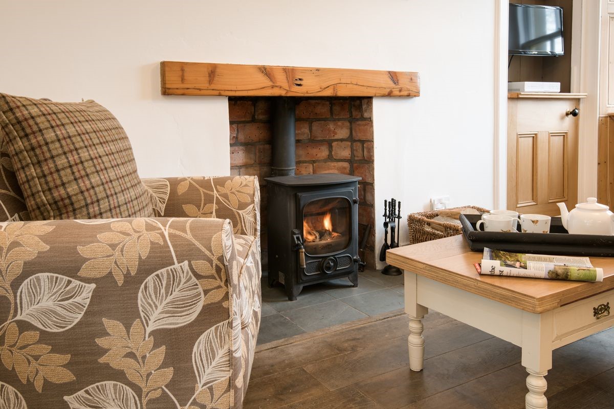 Chestnut Cottage - snuggle up on the armchair by the wood burning stove and enjoy a pot of tea