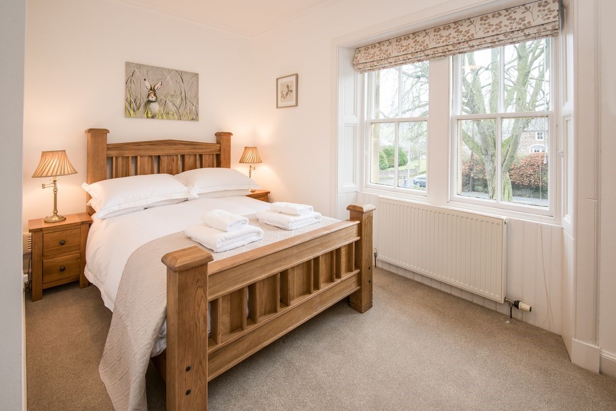 Chestnut Cottage - bedroom one with double bed and bedside tables