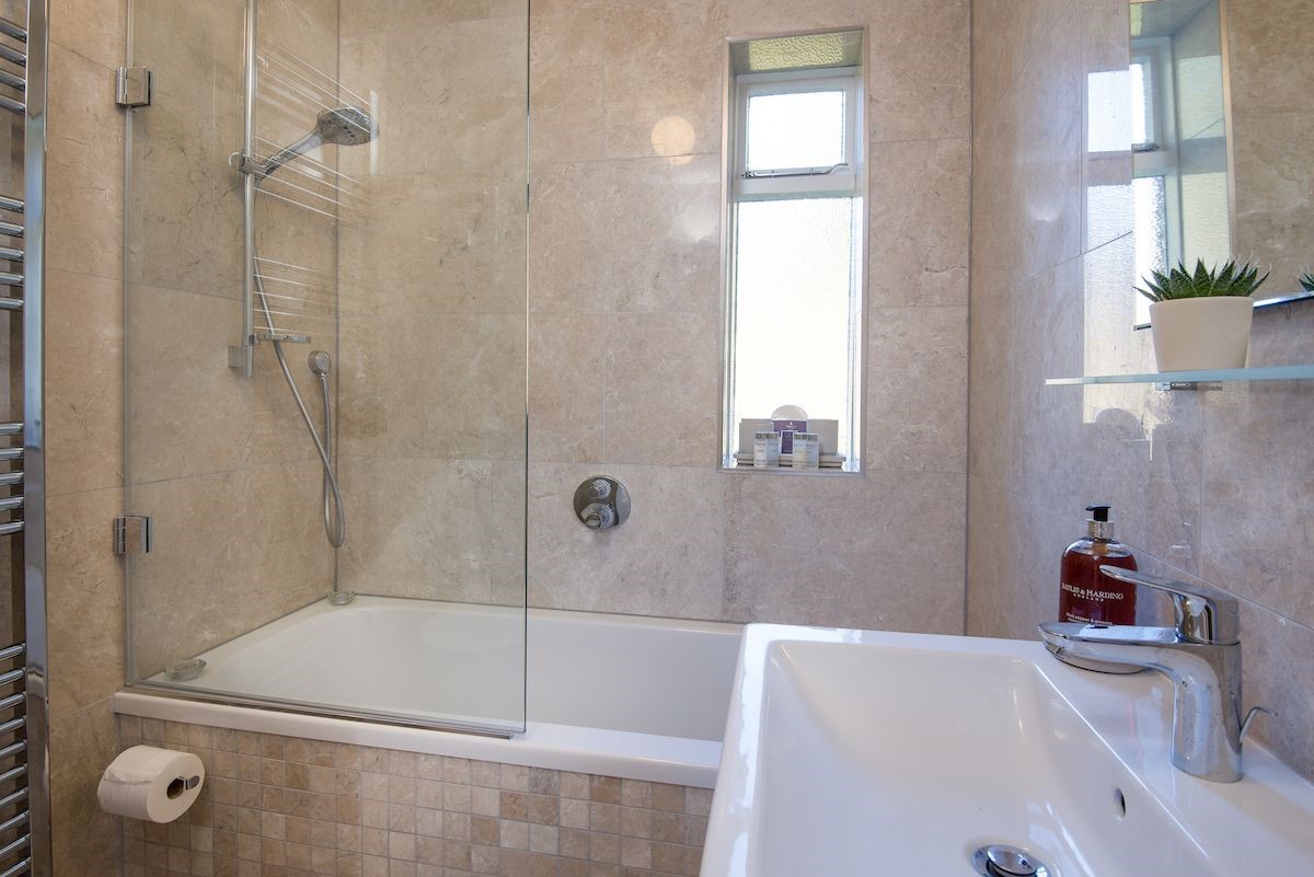 Dipper Cottage - family bathroom with bath and shower over, WC and basin