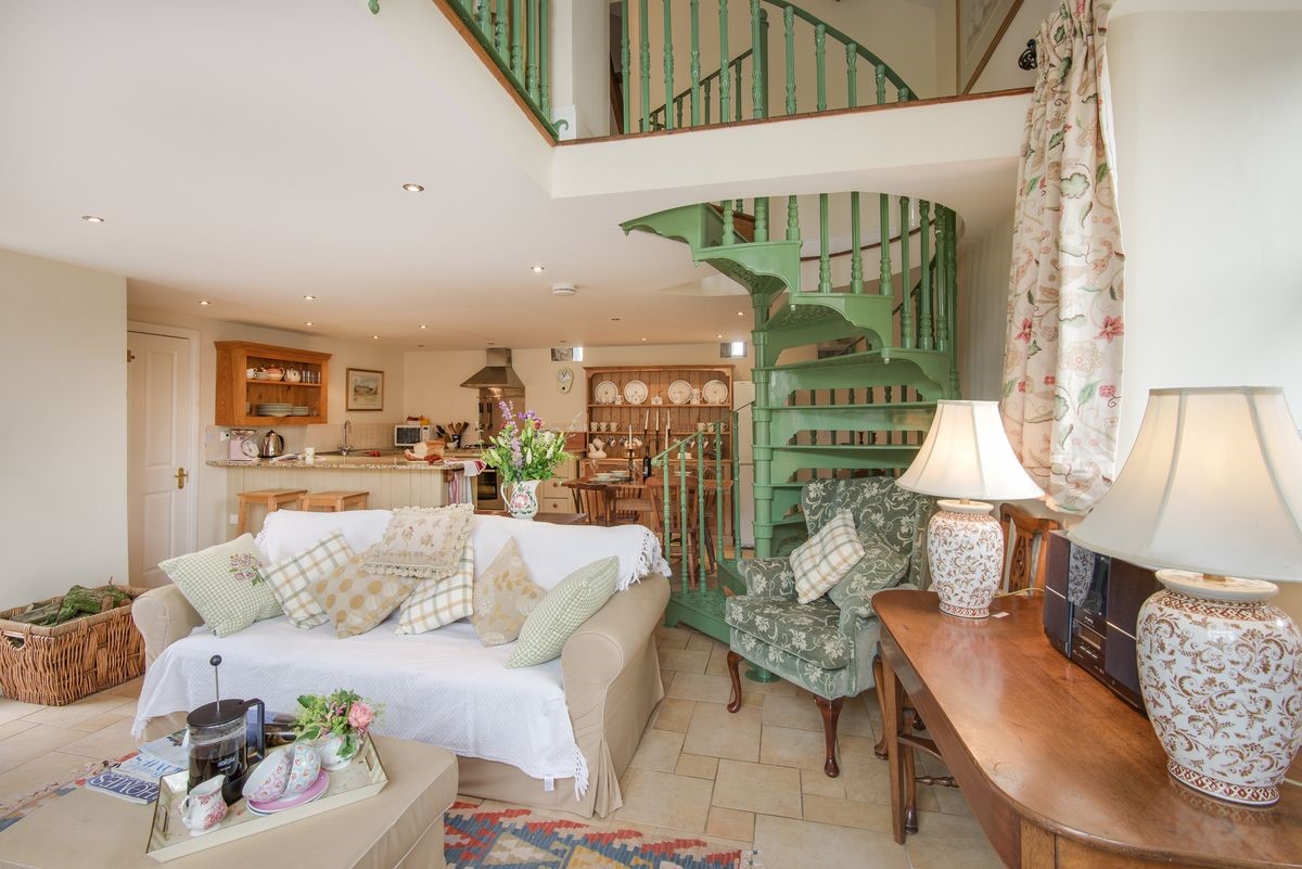 East Cottage - open-plan living area with kitchen and spiral staircase