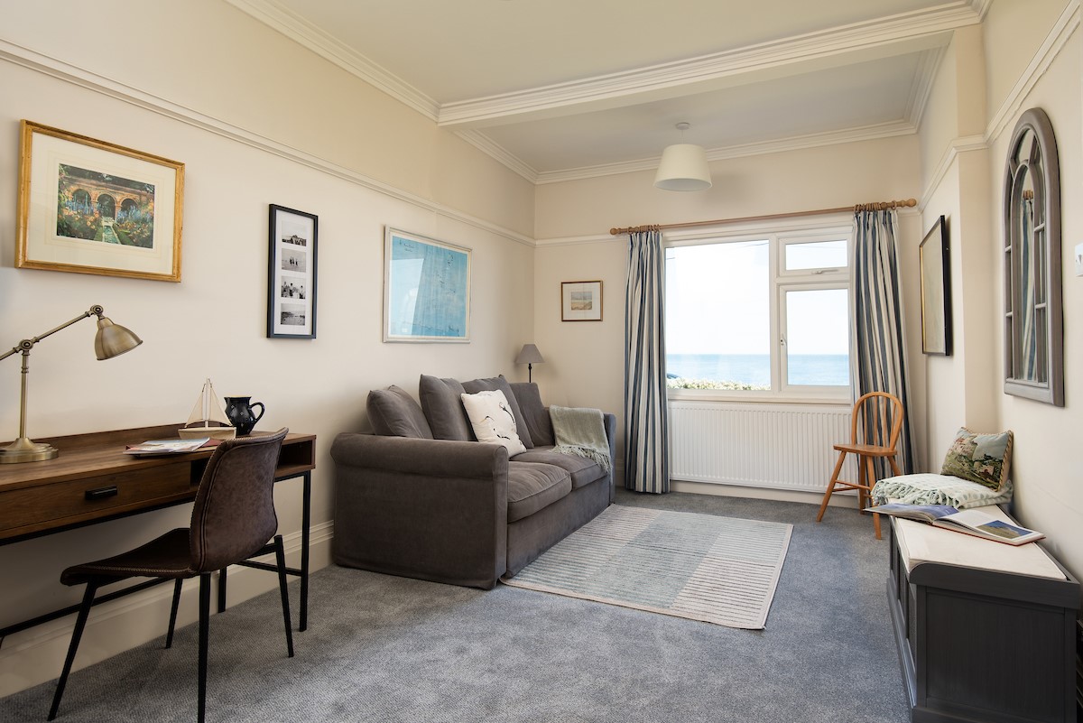 The Fairway - adjoining snug with large sofa, desk, and sea views