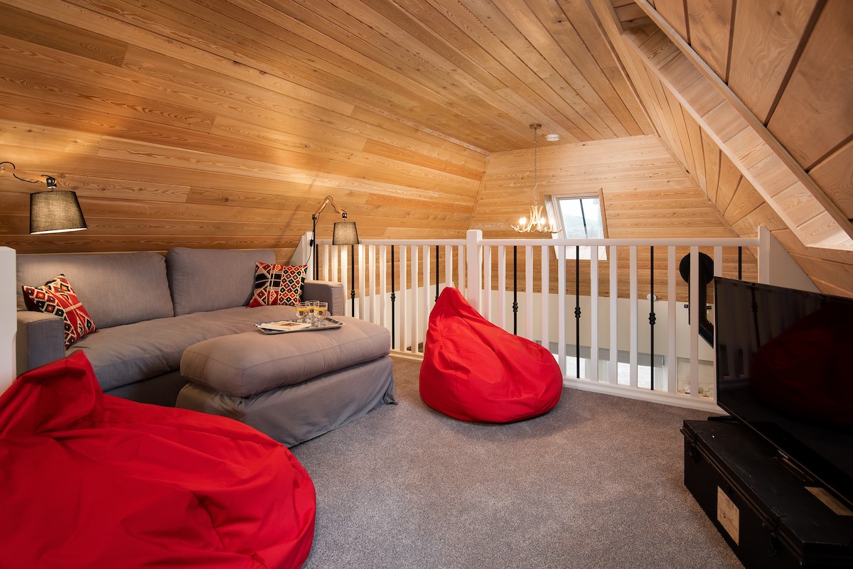 The Bothy at Redheugh - mezzanine level with TV, sofa and beanbags