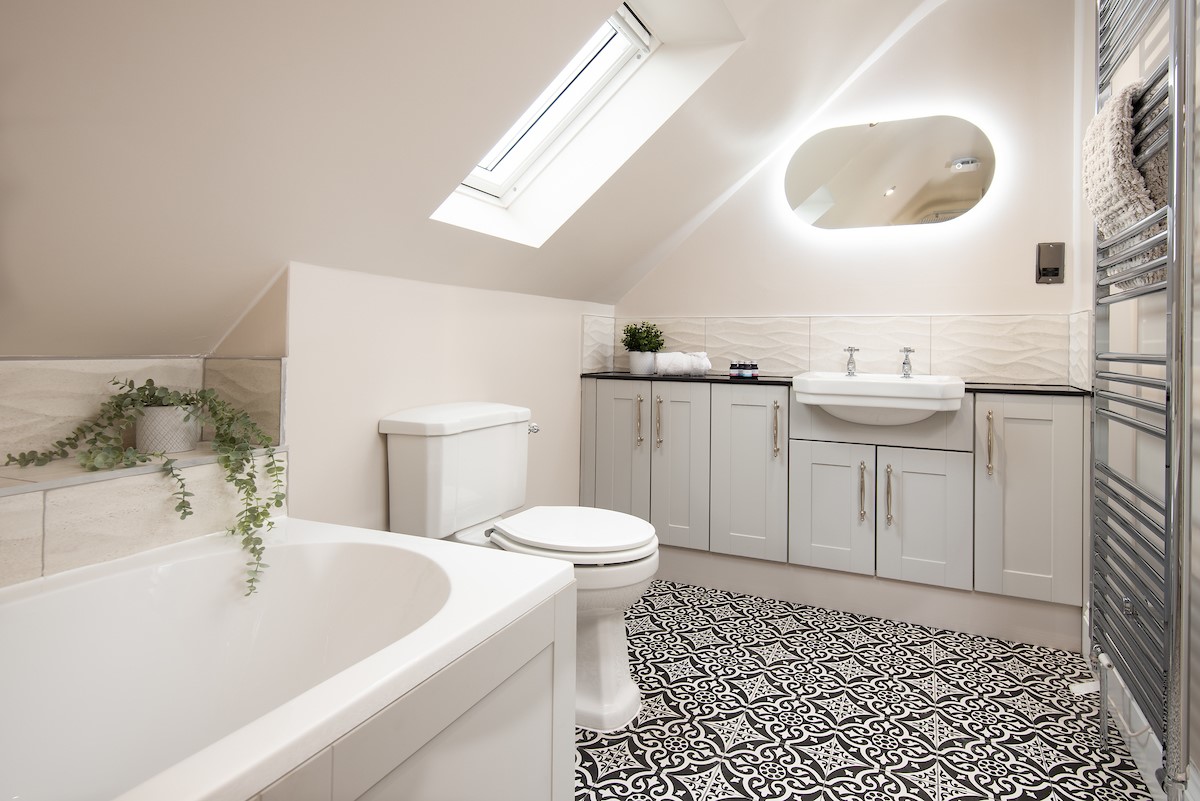 Granary View, Brockmill Farm - en-suite bathroom with large bath with hand-held shower attachment, seperate walk-in shower, WC, basin and illuminated mirror