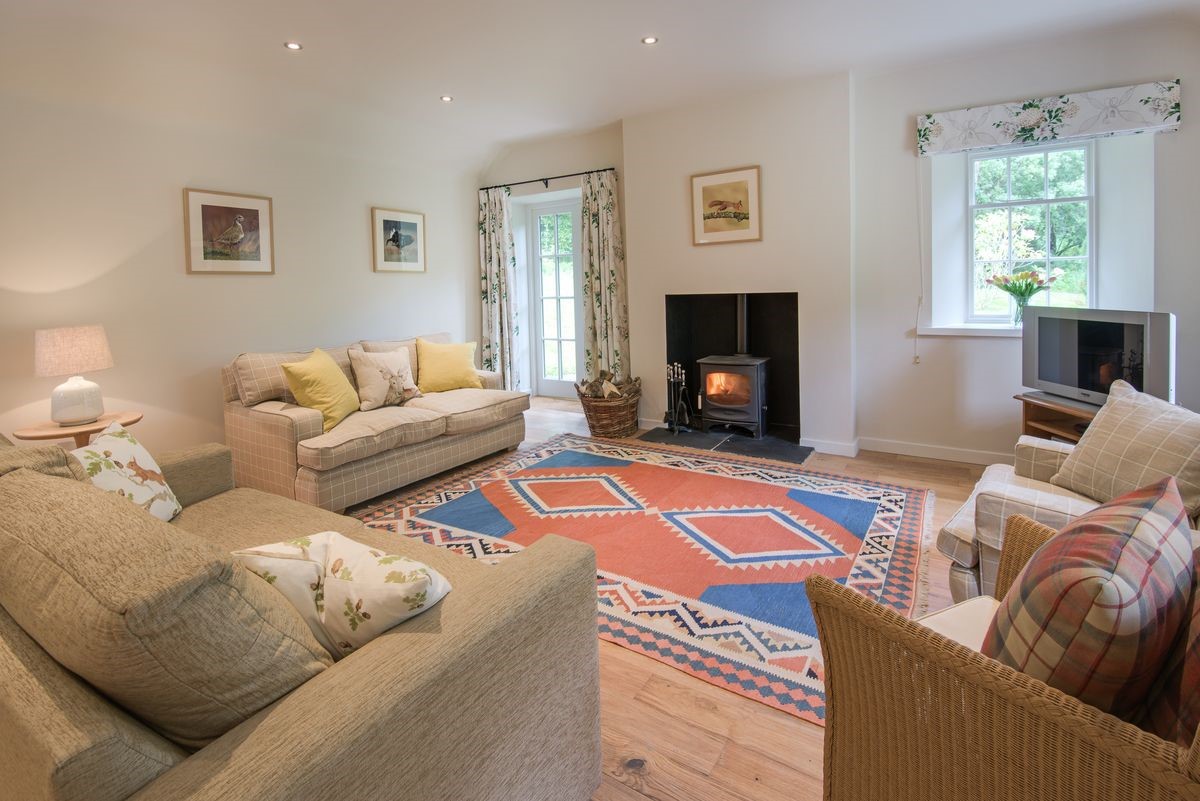 Gardener's Cottage - spacious sitting room with French doors, wood burning stove and ample seating