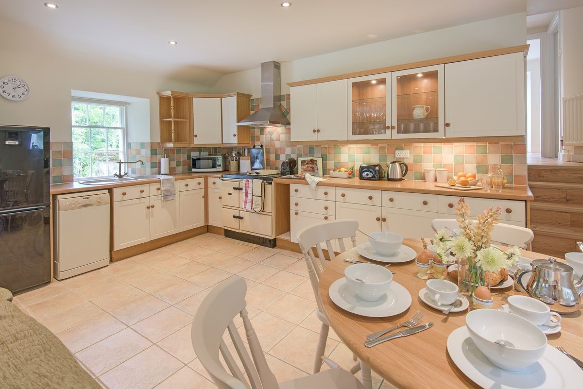 Gardener's Cottage - open-plan kitchen and dining area with stairs leading to the upper ground floor
