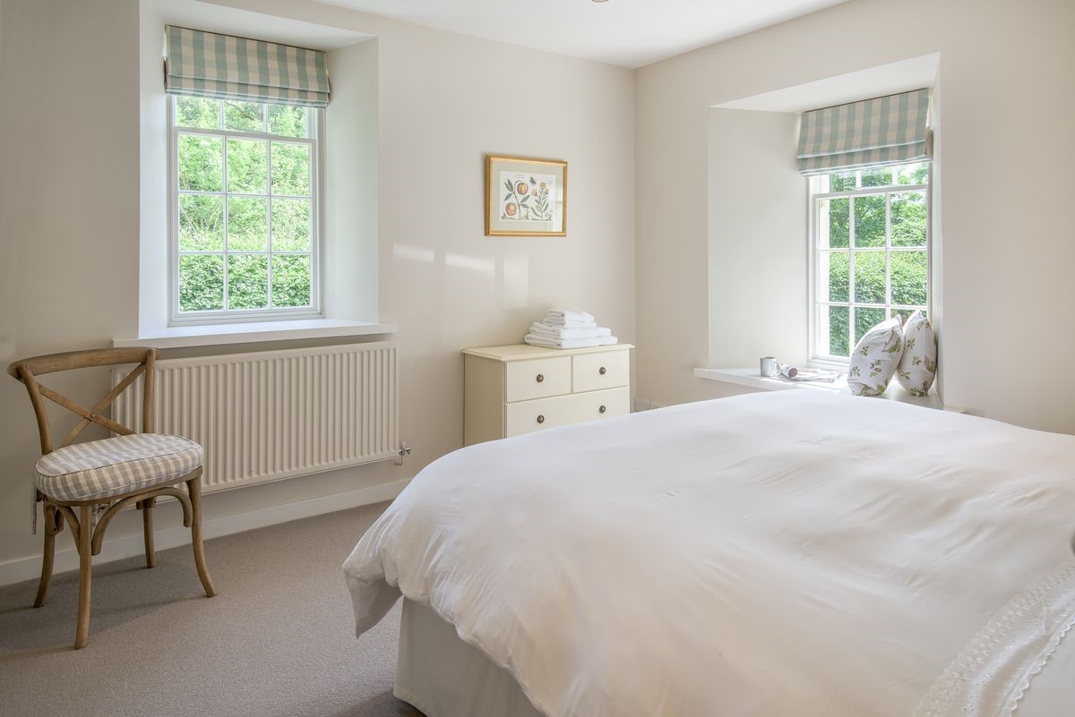 Gardener's Cottage - bedroom one with super king bed, dual aspect views and chest of drawers