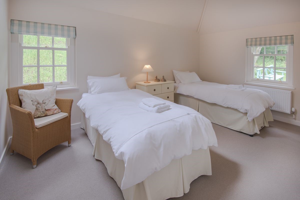 Gardener's Cottage - bedroom three with zip and link beds, chest of drawers, chair and dual aspect views