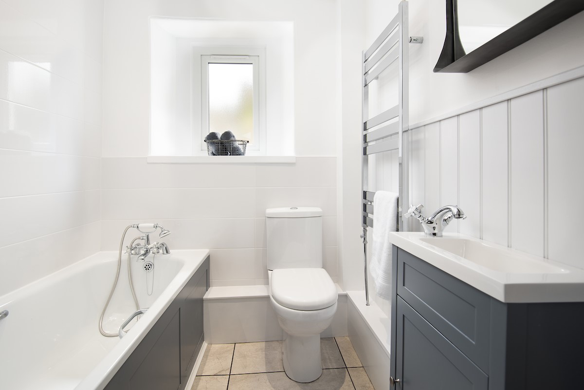 Campsie Cottage - a family bathroom, with a bath and shower over, is located on the ground floor of the cottage