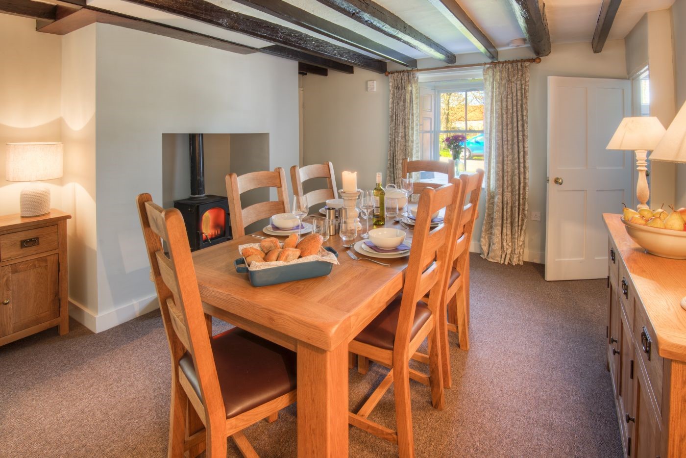 Grove House - dining room with dining table, seating for six guests and wood burning stove