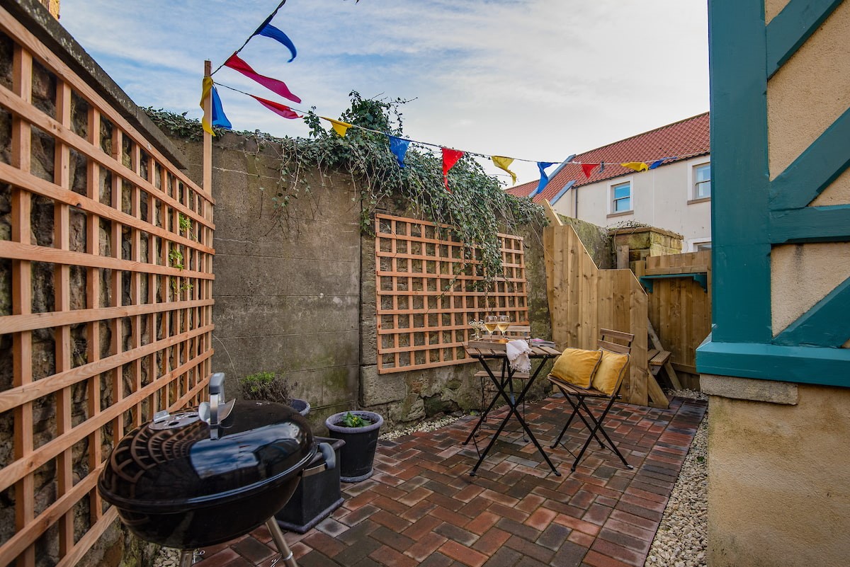 The Loovre - the rear courtyard is complete with a charcoal barbecue and cafe table and chairs for two