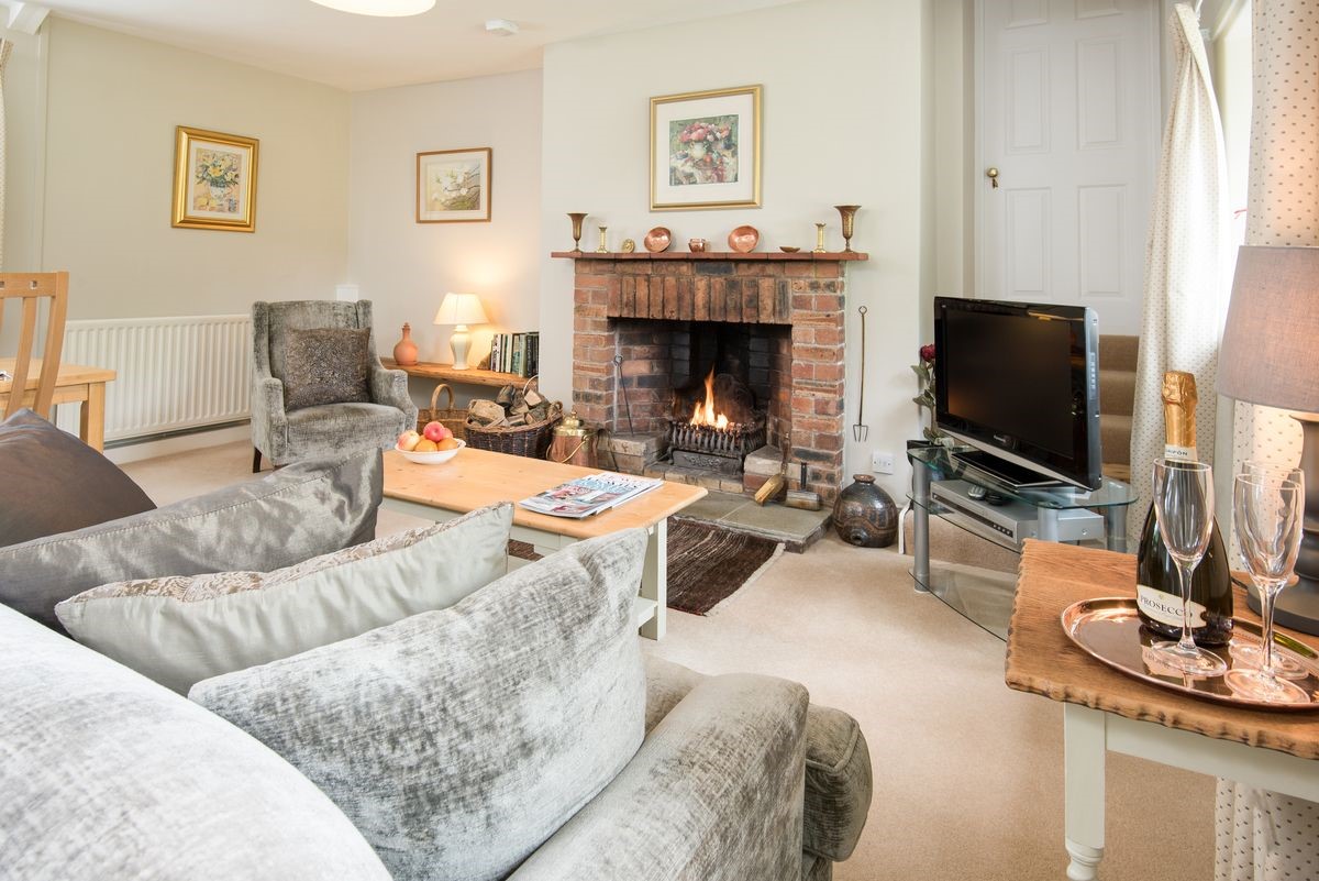 Milfield Hill Cottage - sitting room with open fire