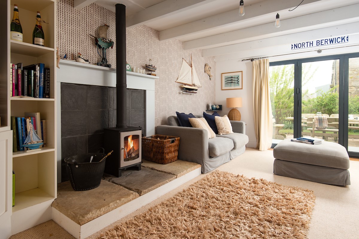 Nook - large bi-fold doors creates a bright space, while the log fire will keep you cosy