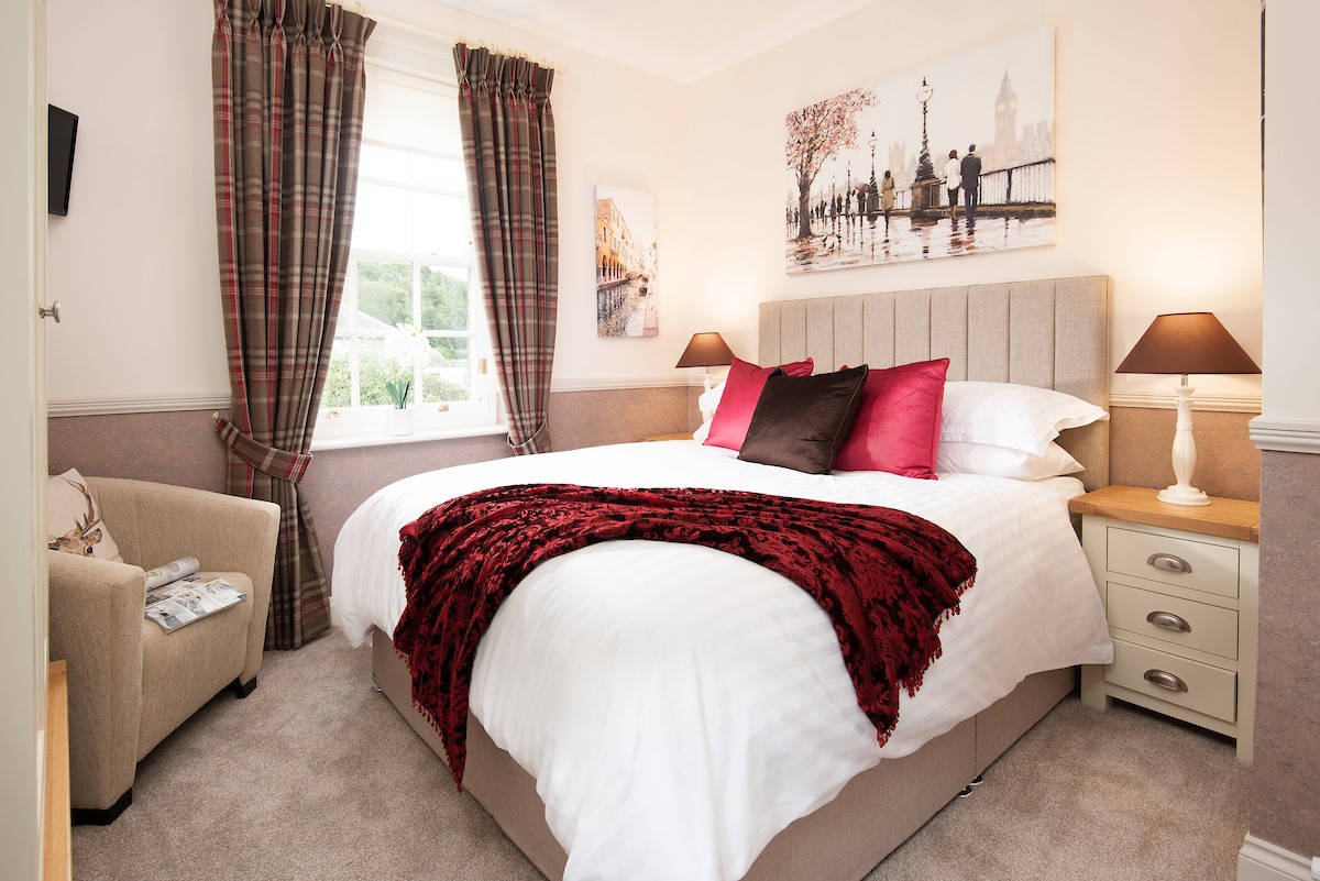 Bank View - bedroom one with double bed, quality linen and single armchair