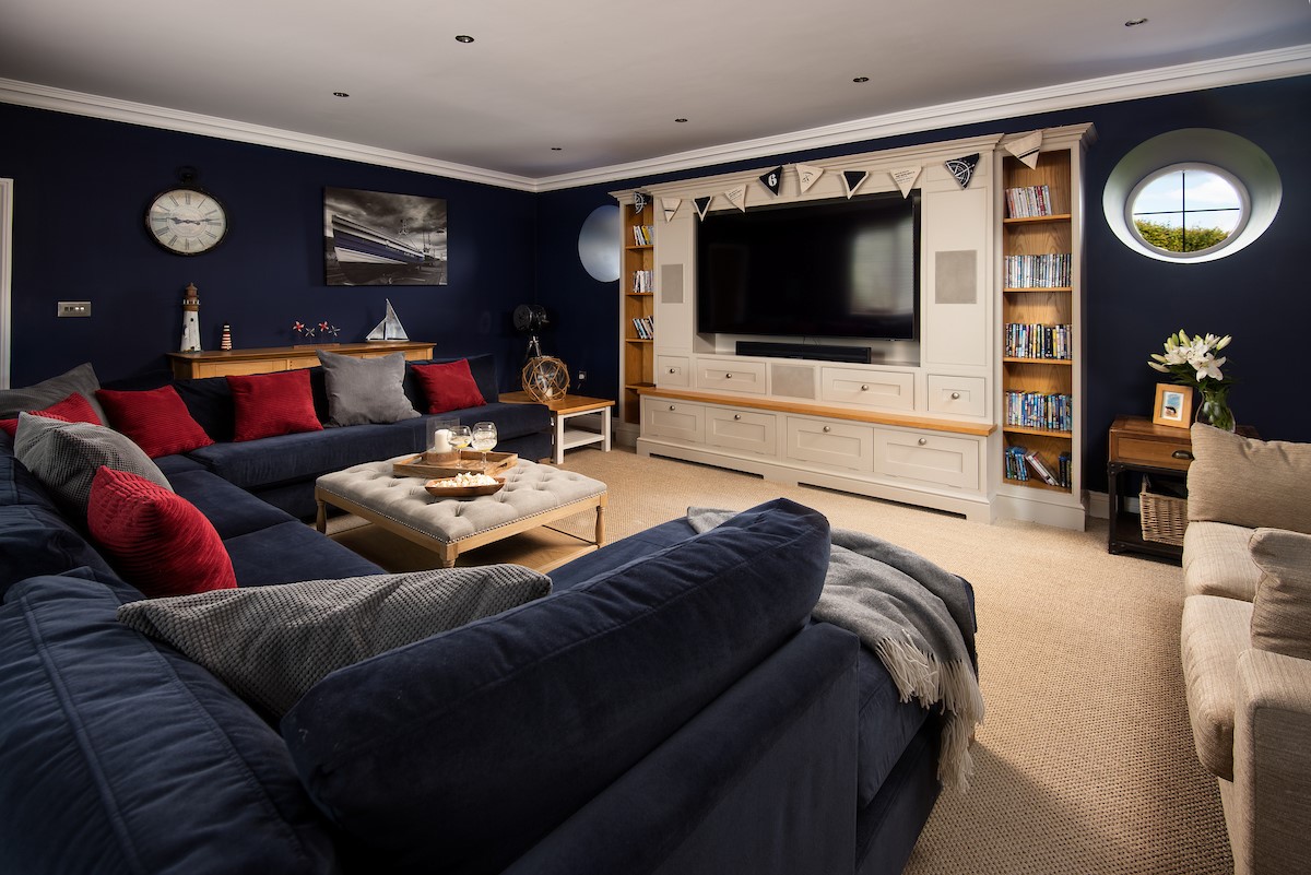 North Star House - the spacious cinema room with comfortable seating and large Smart TV